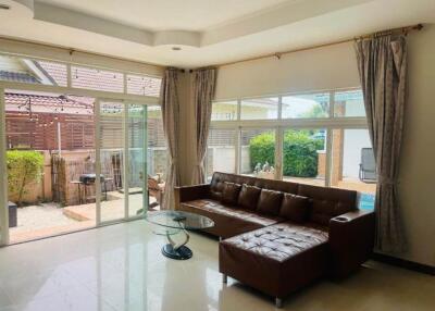 Spacious living room with large windows and a view of the patio