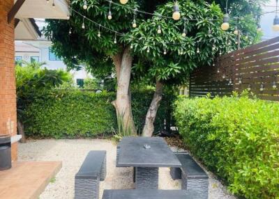 Outdoor seating area with table under tree