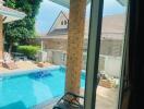 View of the patio and pool area from inside the house