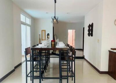 Modern dining area with a tall table and six chairs