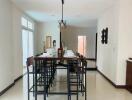 Modern dining area with a tall table and six chairs