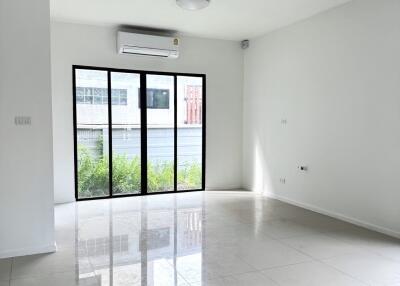 Spacious living room with large windows and air conditioning
