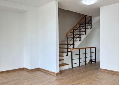 Spacious living area with wooden flooring and staircase, 2nd floor