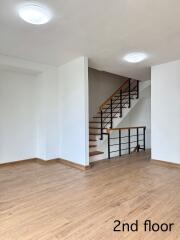 Spacious living area with wooden flooring and staircase, 2nd floor