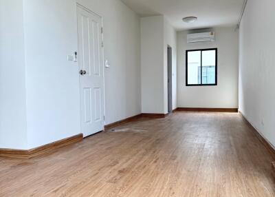 Empty room with wooden flooring and white walls