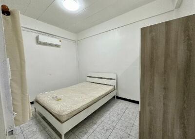 Minimalist bedroom with bed, wardrobe, air conditioner, and tiled floor