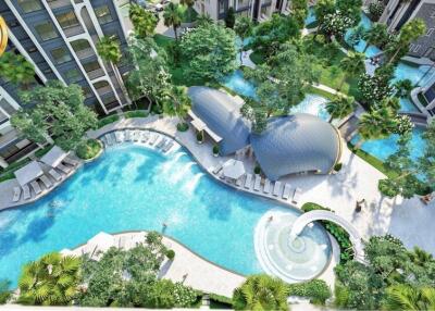 Aerial view of a modern apartment complex with swimming pools and lush gardens