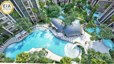 Aerial view of a modern apartment complex with swimming pools and lush gardens