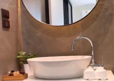 Modern bathroom with a round mirror and sink
