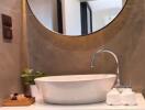 Modern bathroom with a round mirror and sink