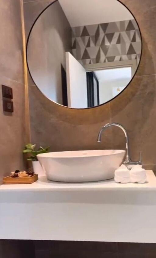 Modern bathroom with a round mirror and sink