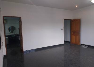 Spacious room with polished floor and open doorways