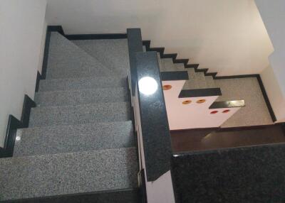 Staircase with black granite railing