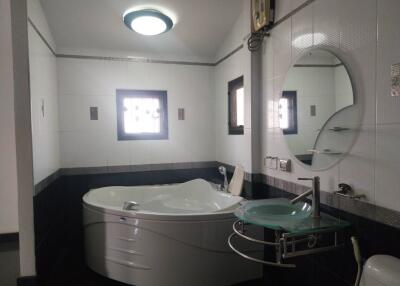 Modern bathroom with bathtub and glass sink