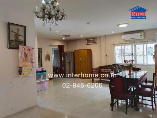 Spacious living area with dining table, chandelier, and modern amenities