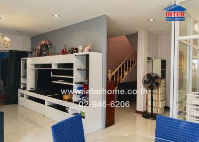 Modern living room with entertainment center and dining area