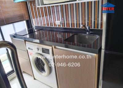 Modern kitchen with washing machine and colorful backsplash