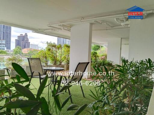 Spacious balcony with outdoor seating and greenery