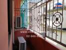 Small balcony with metal railing and air conditioning units