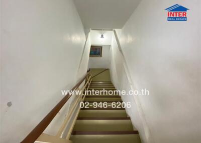 Staircase with white walls and handrails