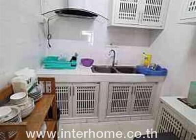 Compact kitchen with appliances and storage