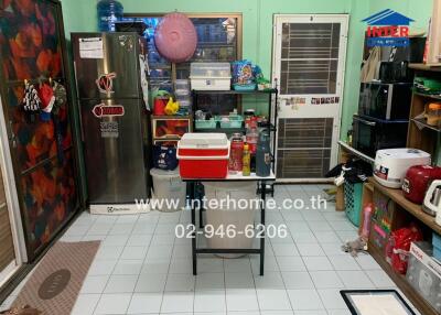 Kitchen area with various appliances and storage