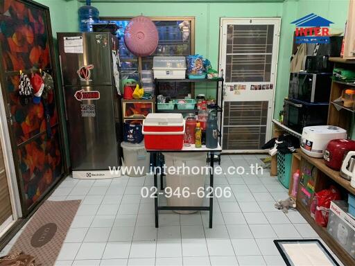 Kitchen area with various appliances and storage