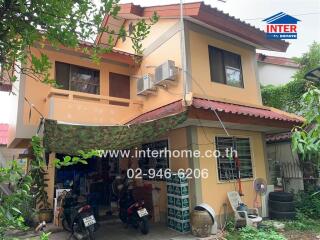 Two-story house with garden and parking area