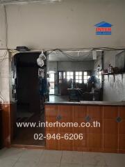 Kitchen with visible counter and wall shelves