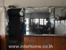 Kitchen with visible counter and wall shelves