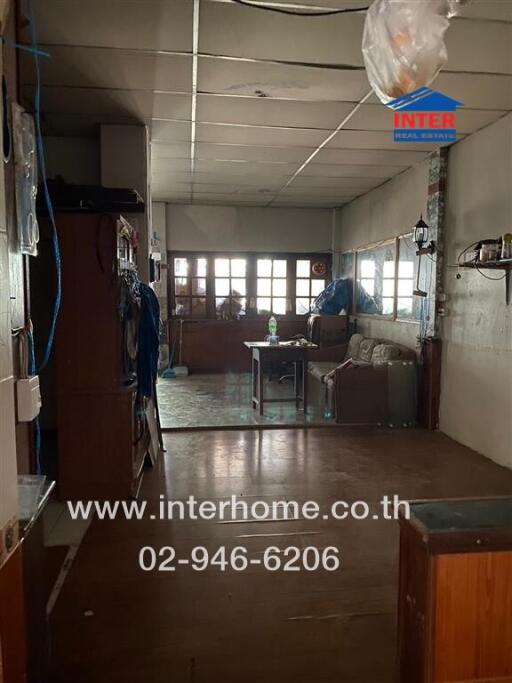 Dimly lit living room with sofa, table and glass windows