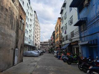 View of a residential alley with motorcycles and buildings