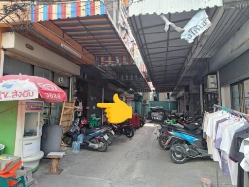 Outdoor view of a commercial area with motorcycles and shopfronts