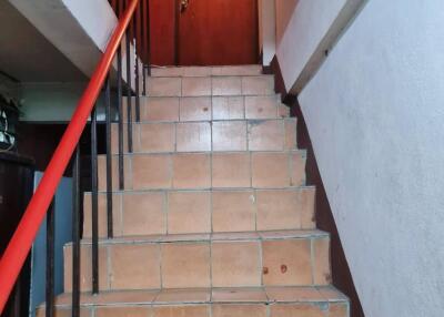 Tiled staircase leading to a door