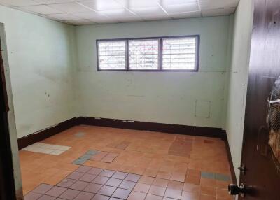 Empty room with tiled floor and ceiling lights