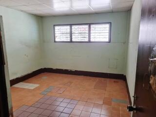 Empty room with tiled floor and ceiling lights
