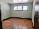 Empty room with tiled floor and ceiling lights