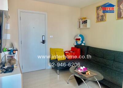 Living room with sofa, coffee table, and wall-mounted TV