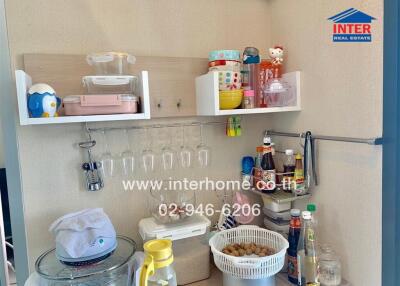 Well-organized kitchen storage area with shelves and various kitchen items