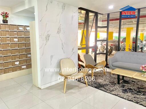 Apartment building lobby with mailboxes and seating area