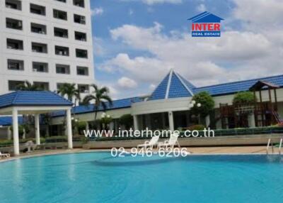 Outdoor swimming pool with building and recreational area