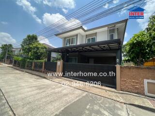 Modern two-story house exterior with driveway and garden