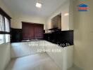 Modern kitchen with white cabinets and black countertops