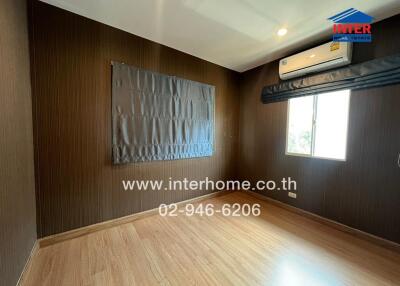 Empty bedroom with wooden floor, air conditioner, and window