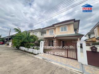 Two-story house with a fenced yard and driveway