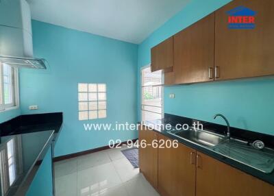 Modern kitchen with blue walls and wooden cabinets