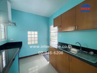 Modern kitchen with blue walls and wooden cabinets