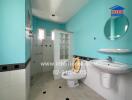 Bathroom with blue walls, white fixtures, and a shower area