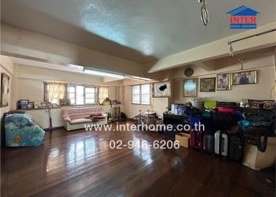 Spacious living room with wooden flooring and ample natural light
