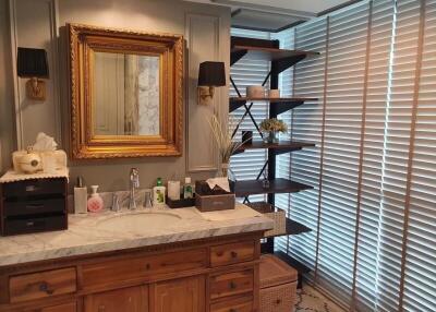Elegant bathroom with marble countertop and shelves